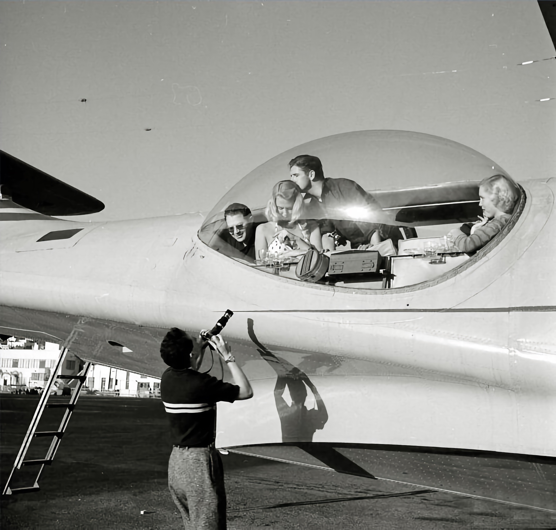 LIFE photographer Loomis Dean photographs models in the starboard observation blister before taking flight.